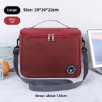Burgundy insulated lunch bag with gray strap on a white background