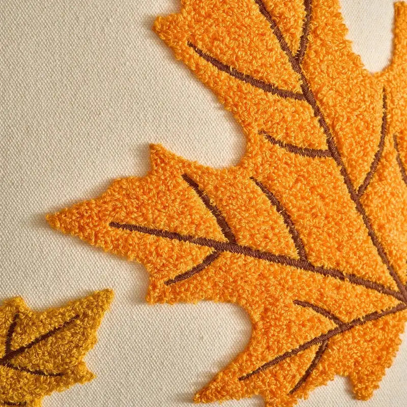 Close-up of textured orange leaves on a beige background