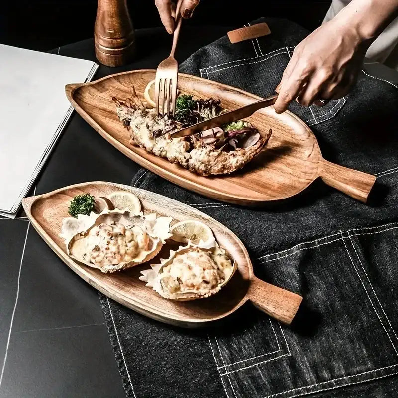 Wooden serving platters with food on a dark surface