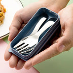 Hands holding a blue compact travel cutlery set with a fork and spoon.
