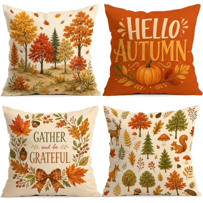 Four decorative throw pillows arranged in a 2x2 grid, each with an autumn-themed print. The top-left pillow shows an autumn forest scene on a cream background.