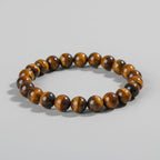 Brown beaded bracelet on a wooden surface with 'Self-Love' text