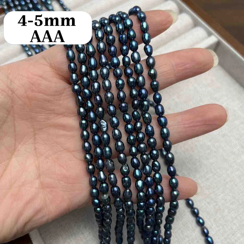 A hand holding multiple strands of dark blue iridescent oval beads, with a white label reading '4-5mm AAA' in the top left corner.