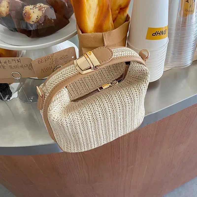 Woven handbag on a wooden surface with a blurred background