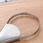 Metallic kitchen tool on a wooden surface
