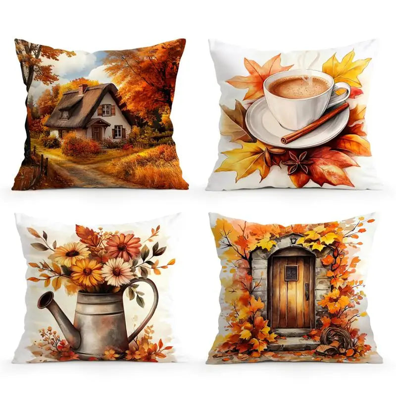Four square decorative throw pillows arranged in a 2x2 grid on a white background. The top-left pillow shows a autumn cottage scene with orange trees and a path.