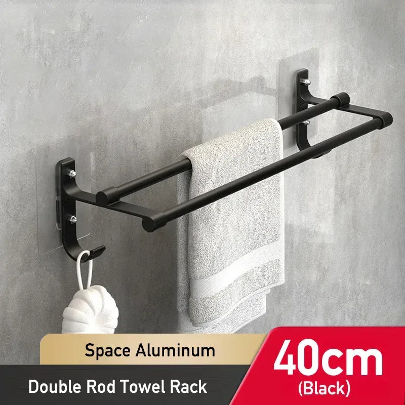 Black double rod towel rack with a towel hanging on a gray wall.