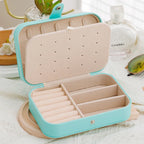 Open jewelry case with compartments on a light background