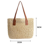 Woven handbag with brown straps and dimensions on a white background