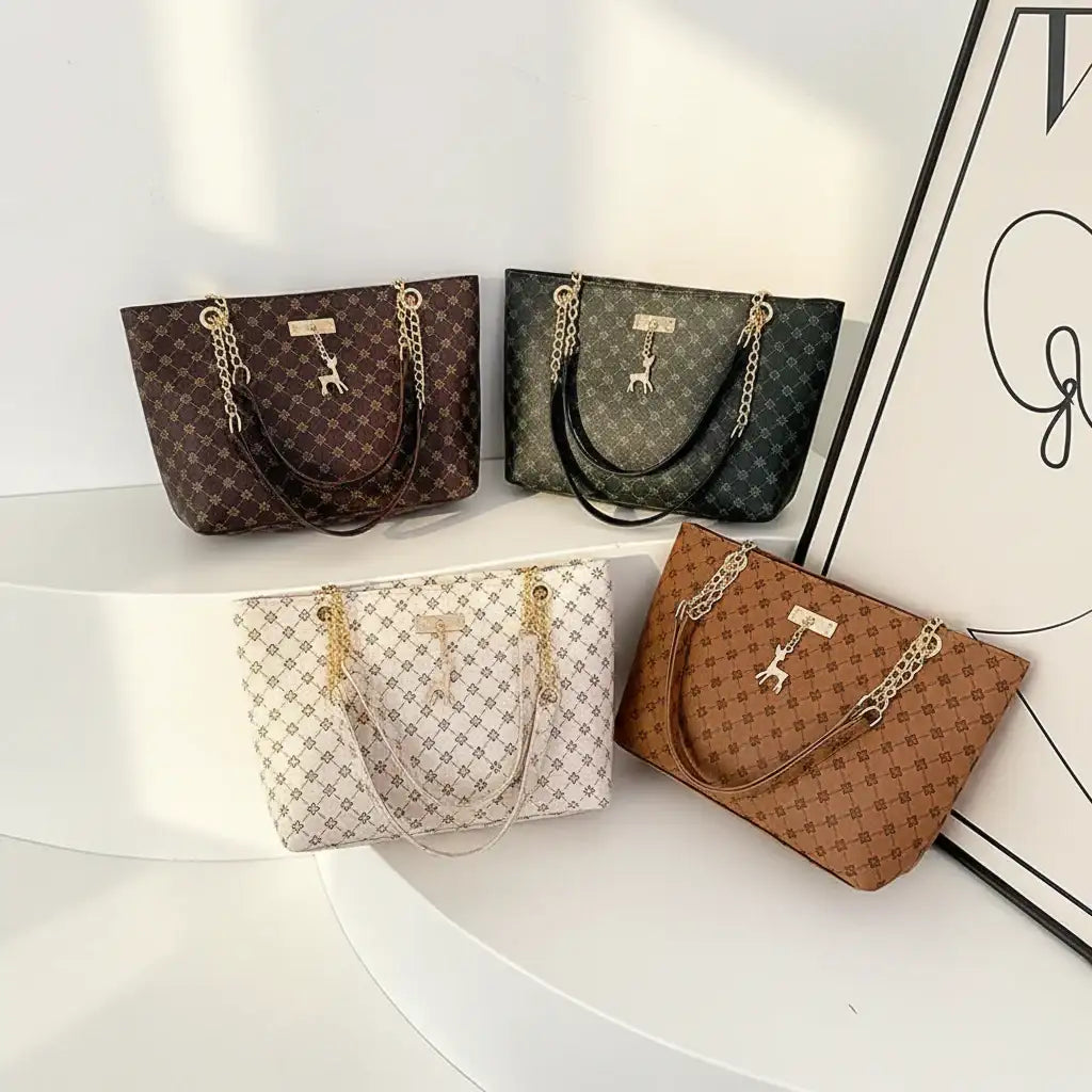Four handbags in different colors and patterns on a white surface with a decorative frame in the background.