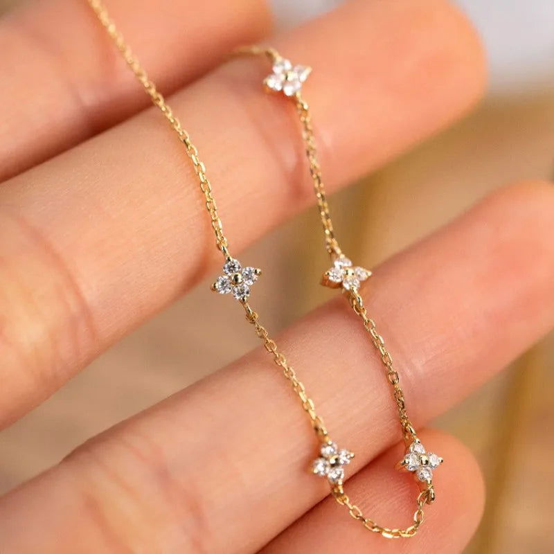 The EMESA HOME 925 Sterling Silver Plated 18k Gold Shiny Zircon Flower Bracelet is a delicate and elegant piece of jewelry designed to enhance a woman's style with its exquisite craftsmanship. - Emesa Home