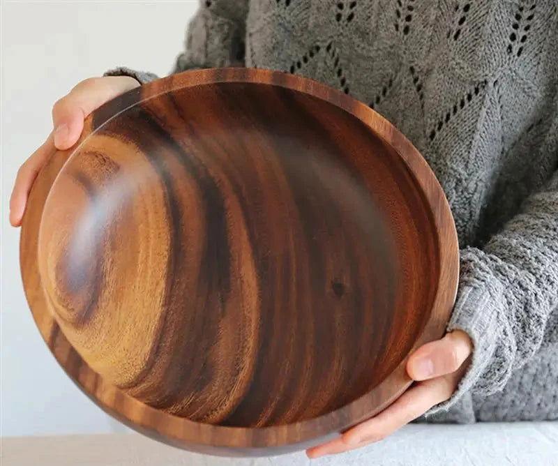 The EMESA HOME Natural Wooden Bowl is handcrafted from Acacia wood, perfect for serving fruit or salad. Its elegant design adds a natural touch to any kitchen. - Emesa Home