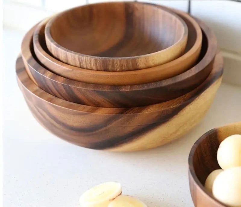 The EMESA HOME Natural Wooden Bowl is handcrafted from Acacia wood, perfect for serving fruit or salad. Its elegant design adds a natural touch to any kitchen. - Emesa Home